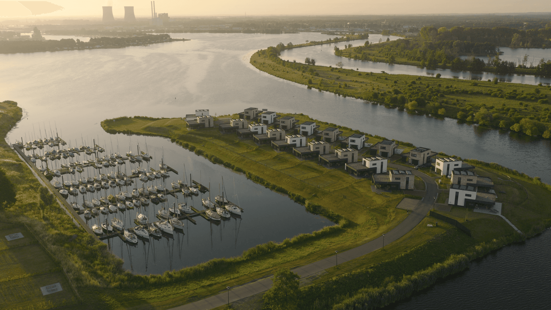 Aerial view of a waterfront holiday resort representing the BungalowNet Group hospitality ecosystem.
