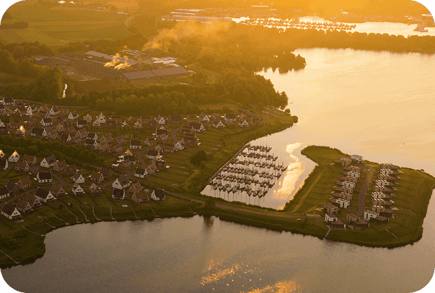 Aerial view of a holiday park and marina representing park development.